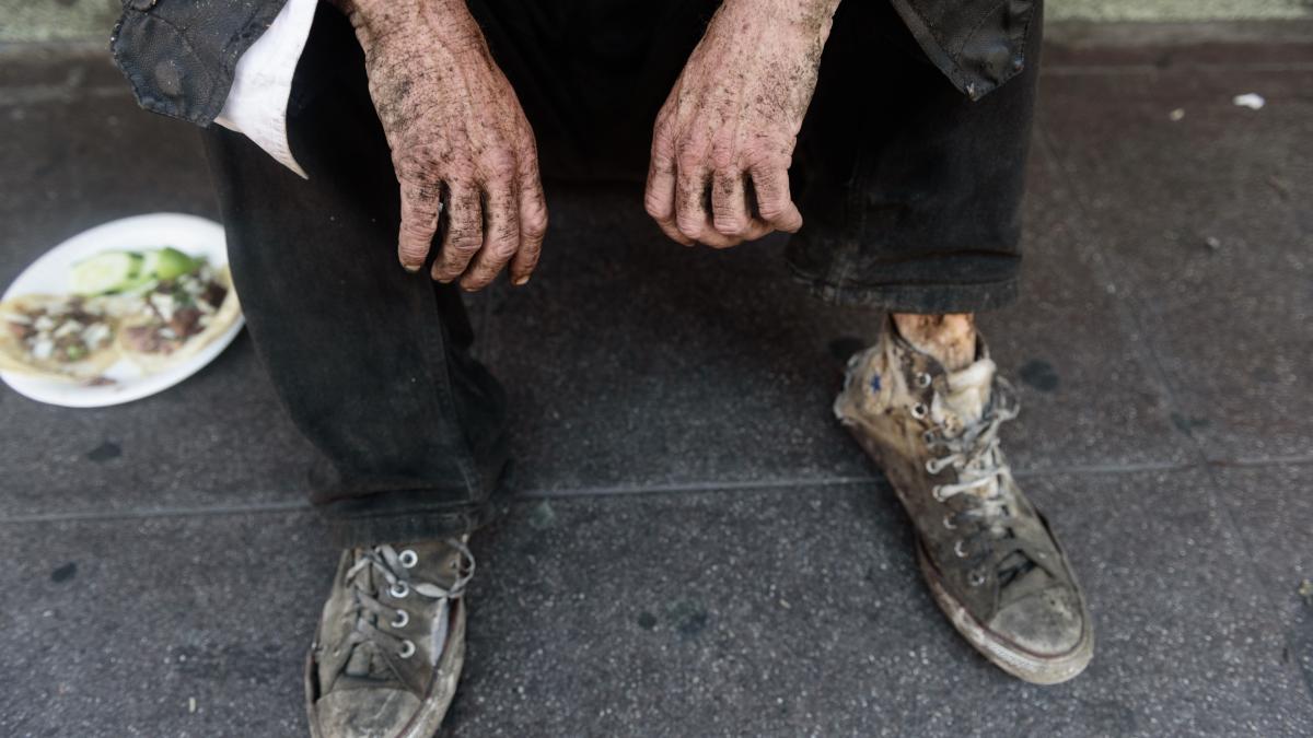 An elderly man sitting down